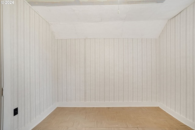 interior space featuring lofted ceiling and parquet floors