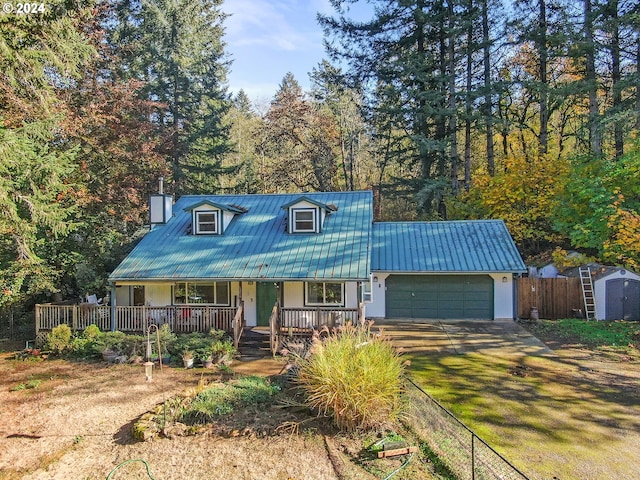 view of front of home with a storage unit, a garage, and a porch