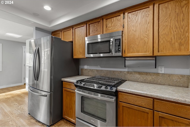 kitchen featuring stainless steel appliances and light hardwood / wood-style floors