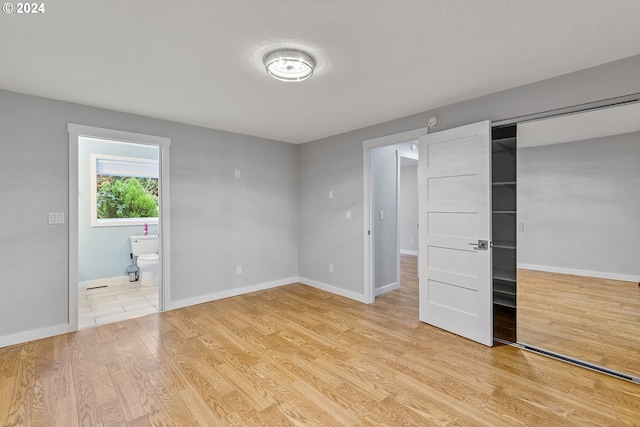 31205 NE 152nd Ave, Battle Ground, WA 98604 - unfurnished bedroom with light wood-style floors, a closet, baseboards, and connected bathroom