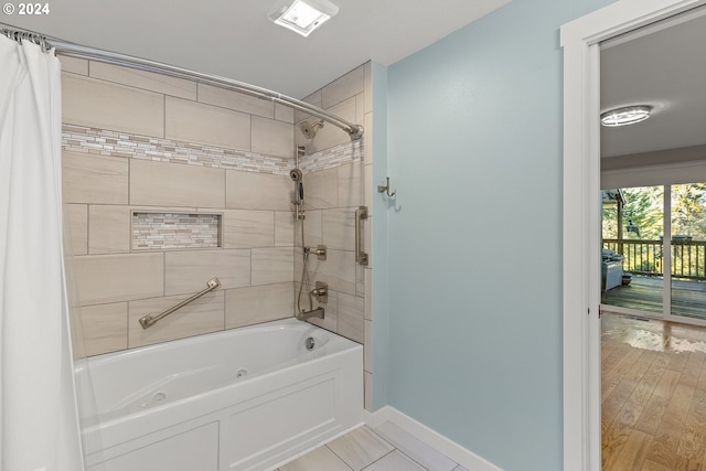 bathroom featuring hardwood / wood-style floors and shower / tub combo with curtain