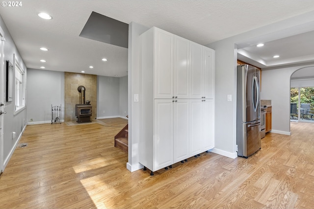 31205 NE 152nd Ave, Battle Ground, WA 98604 - living area with arched walkways, light wood finished floors, recessed lighting, baseboards, and a wood stove