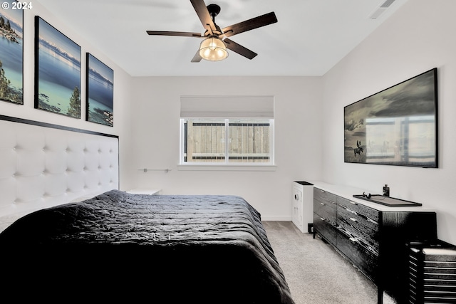 bedroom with light carpet and ceiling fan