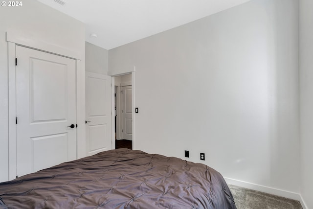 carpeted bedroom with a closet