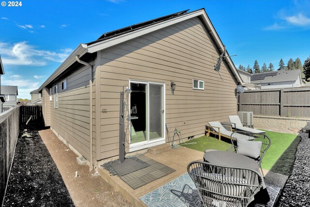 rear view of property featuring a patio area and central air condition unit