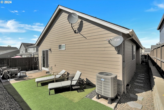 rear view of property featuring cooling unit and a patio area