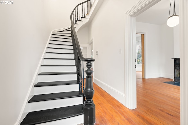 stairway featuring hardwood / wood-style flooring