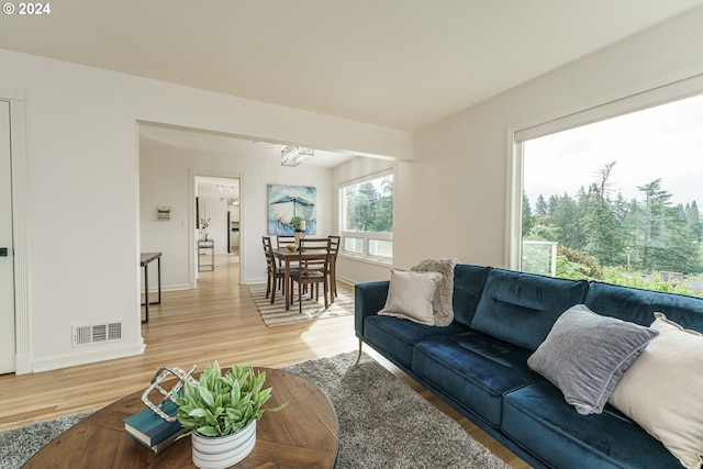 living room featuring hardwood / wood-style flooring and a chandelier