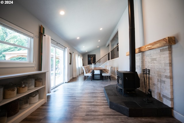 living room with a wood stove and dark hardwood / wood-style flooring