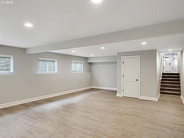 basement with light hardwood / wood-style flooring