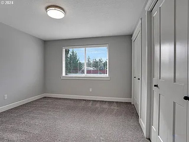 unfurnished bedroom featuring light colored carpet