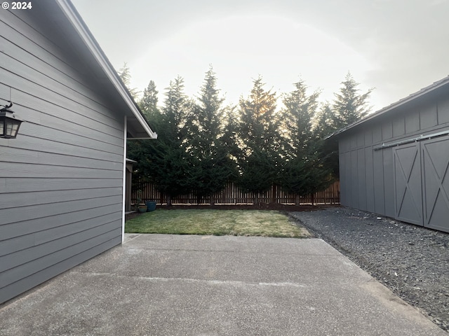 view of patio featuring a storage unit