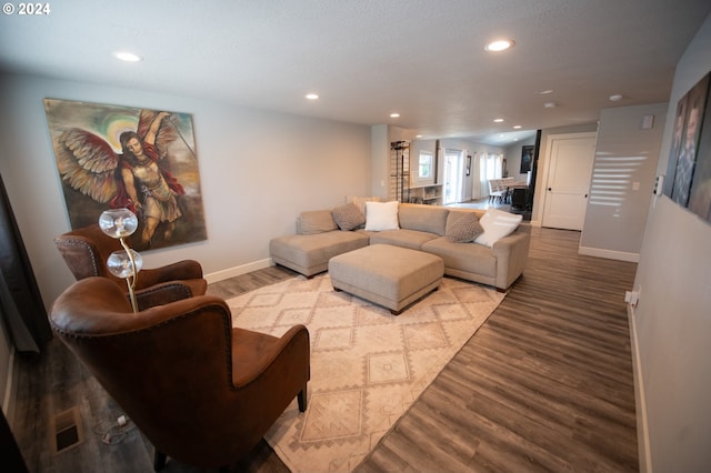 living room featuring a textured ceiling and light hardwood / wood-style floors