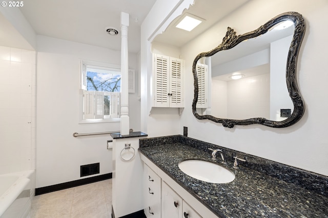 bathroom with vanity, tile patterned floors, and washtub / shower combination