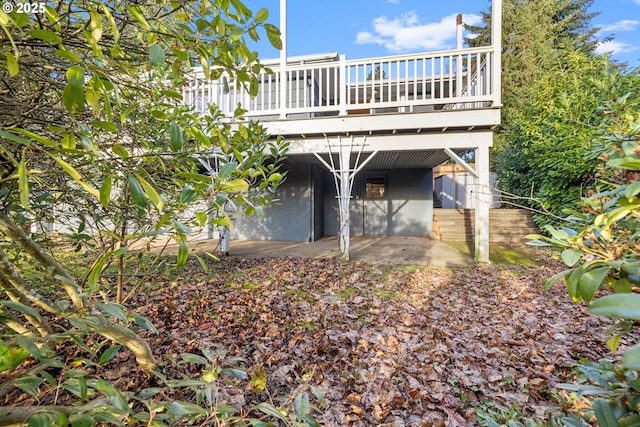 exterior space with a wooden deck and a patio area