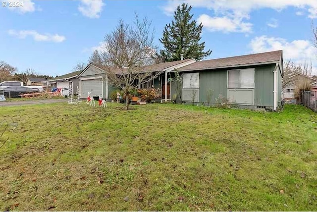 view of front of house featuring a garage and a front lawn