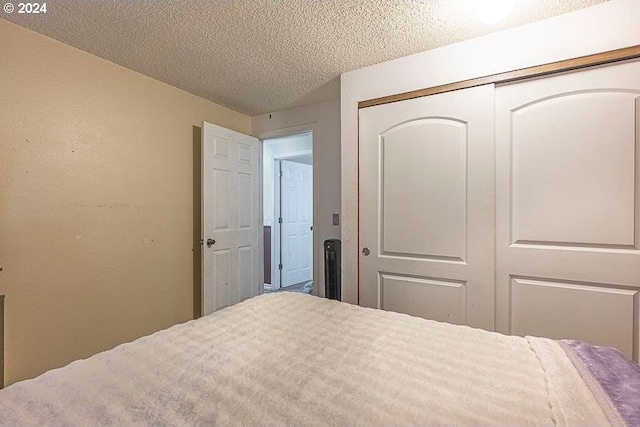 bedroom with a closet and a textured ceiling