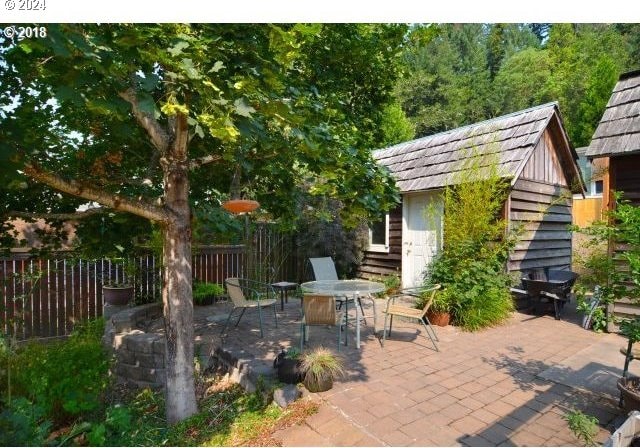 view of patio / terrace with a shed