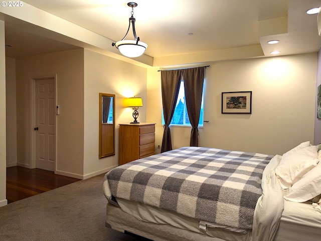 bedroom with dark colored carpet