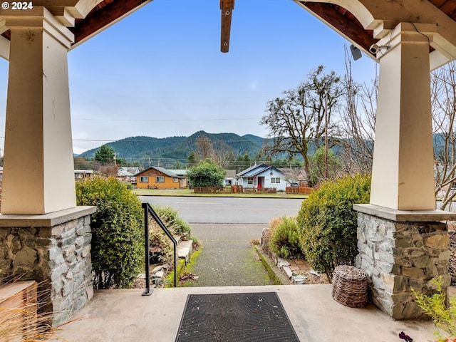 view of yard featuring a mountain view and a porch