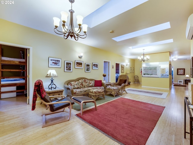 living room with a skylight, light hardwood / wood-style floors, and a notable chandelier