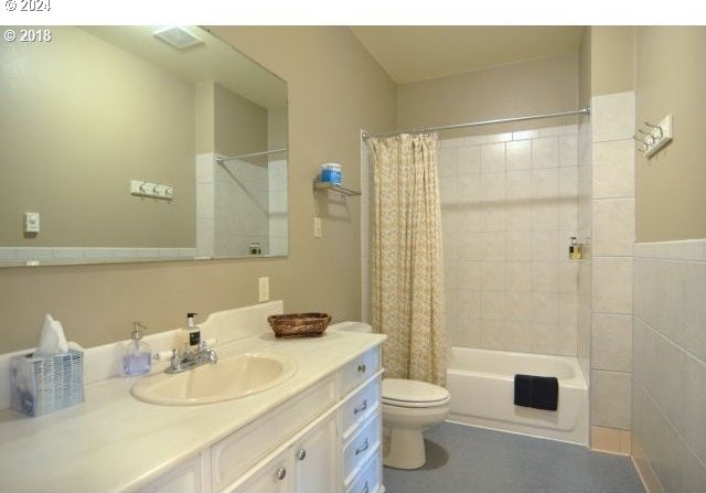 full bathroom with vanity, toilet, and shower / bath combo with shower curtain