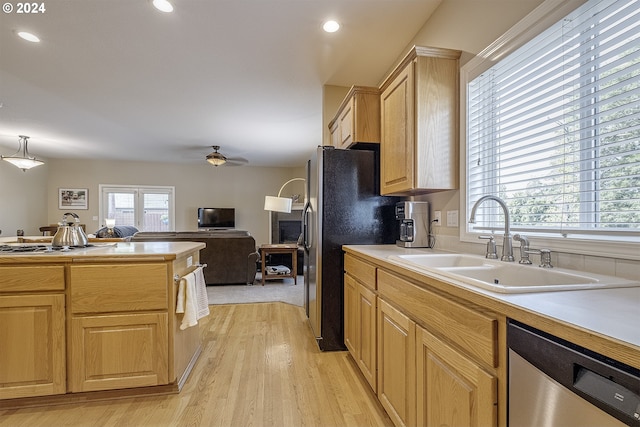 kitchen featuring ceiling fan, light wood-type flooring, light brown cabinets, dishwasher, and sink