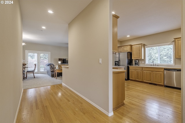 hallway with sink and light carpet