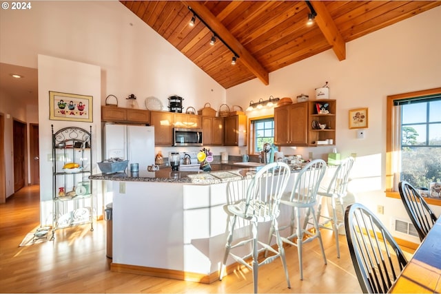 kitchen with light hardwood / wood-style flooring, high vaulted ceiling, white fridge with ice dispenser, wooden ceiling, and beamed ceiling