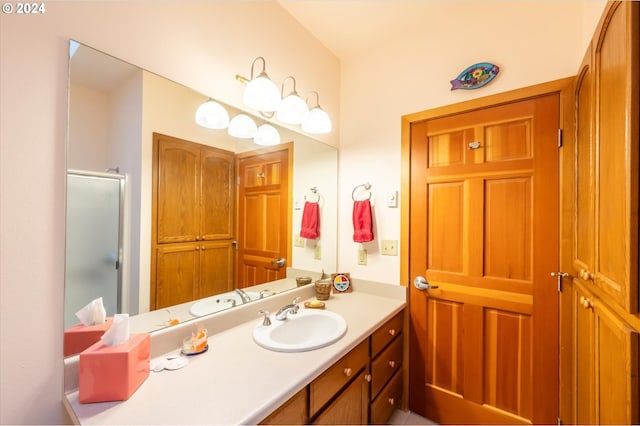 bathroom with a shower with door and vanity