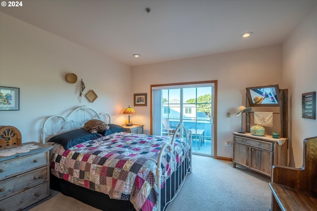 bedroom with light carpet and access to outside