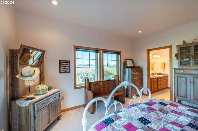 carpeted bedroom featuring ensuite bathroom