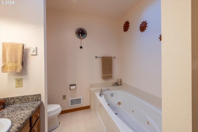 bathroom with tile patterned floors, vanity, toilet, and a bathtub