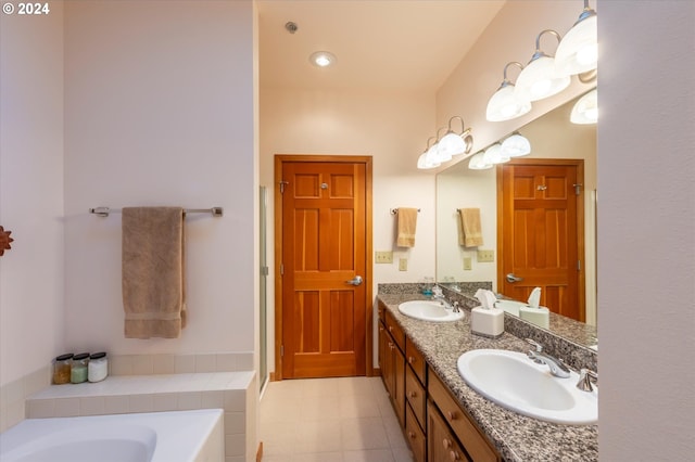 bathroom with vanity, a bath, and tile patterned flooring