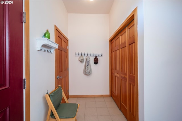 hallway featuring light tile patterned floors