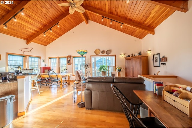 living room with light hardwood / wood-style flooring, wooden ceiling, track lighting, ceiling fan, and beam ceiling