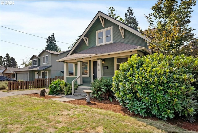 view of front facade featuring covered porch and a front yard