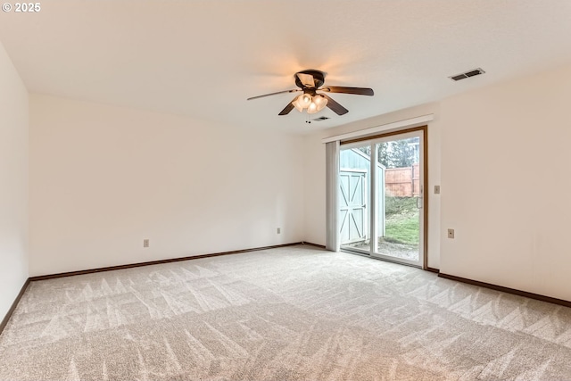 unfurnished room with ceiling fan and carpet