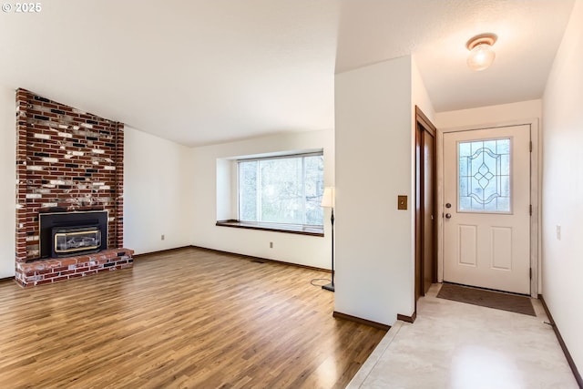 foyer with lofted ceiling, hardwood / wood-style floors, and a wealth of natural light