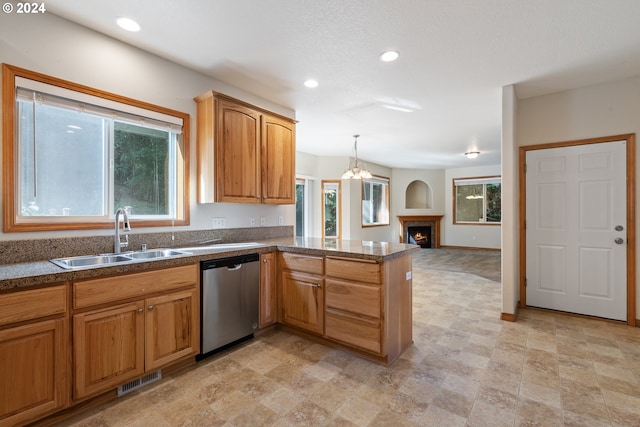 kitchen with hanging light fixtures, dishwasher, an inviting chandelier, sink, and kitchen peninsula