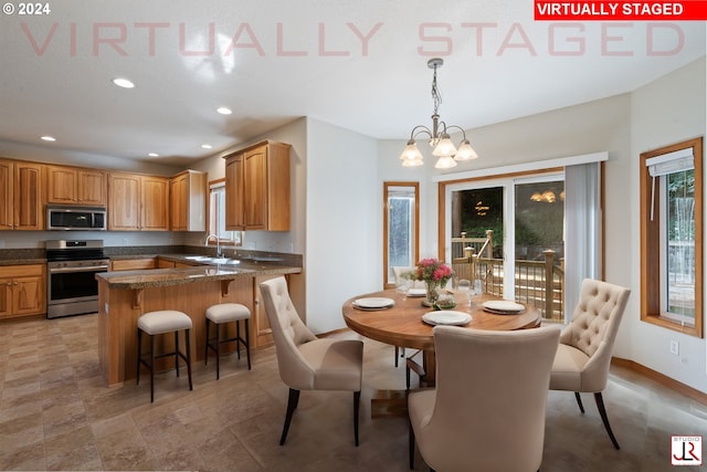 dining room featuring a chandelier and sink