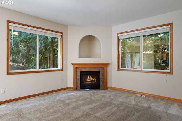 unfurnished living room with a fireplace and carpet flooring