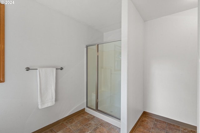 bathroom featuring a shower with door