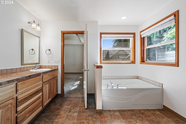 bathroom featuring vanity and a bath