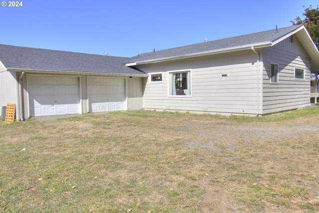 view of front of home with a front yard and a garage