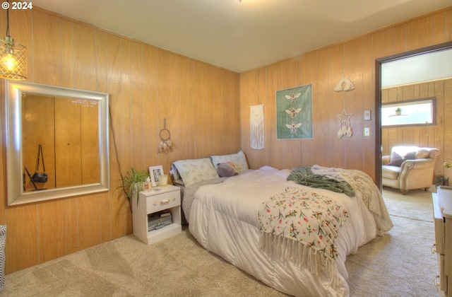 carpeted bedroom with wooden walls