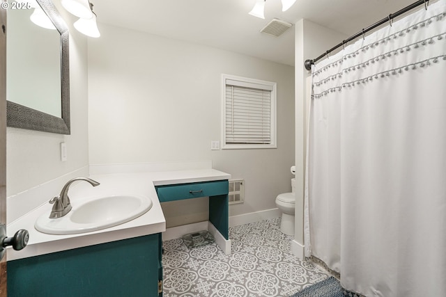 bathroom with tile patterned flooring, vanity, and toilet