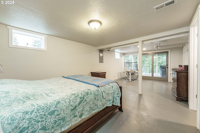 bedroom with access to outside and a textured ceiling