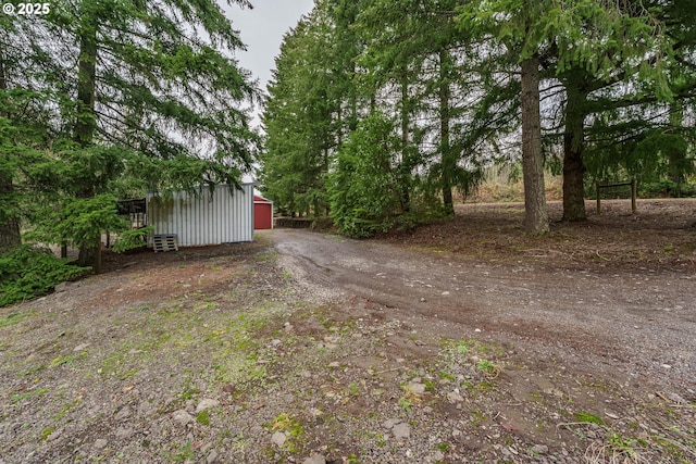 view of yard featuring an outbuilding and a garage