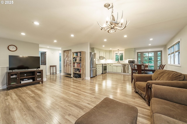 living room featuring light hardwood / wood-style floors and a chandelier